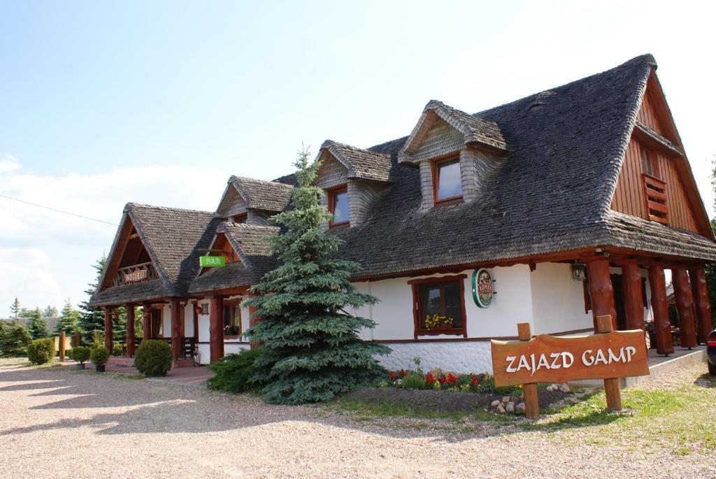 a large building with a sign in front of it at GAMP Paweł Sawicki in Kleszczele