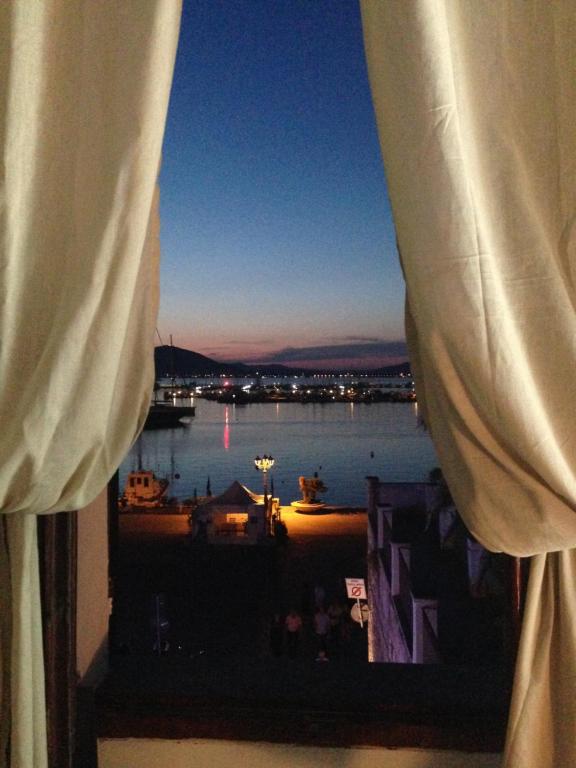 a view from a window of a boat in the water at Palazzo Bolasco in Alghero