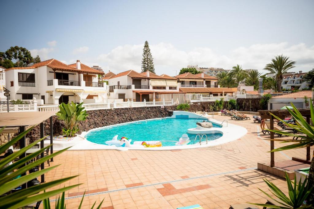 una piscina en un complejo con gente dentro en Sunny Large Terrace Apartment in Center of Las Americas, en Playa de las Américas