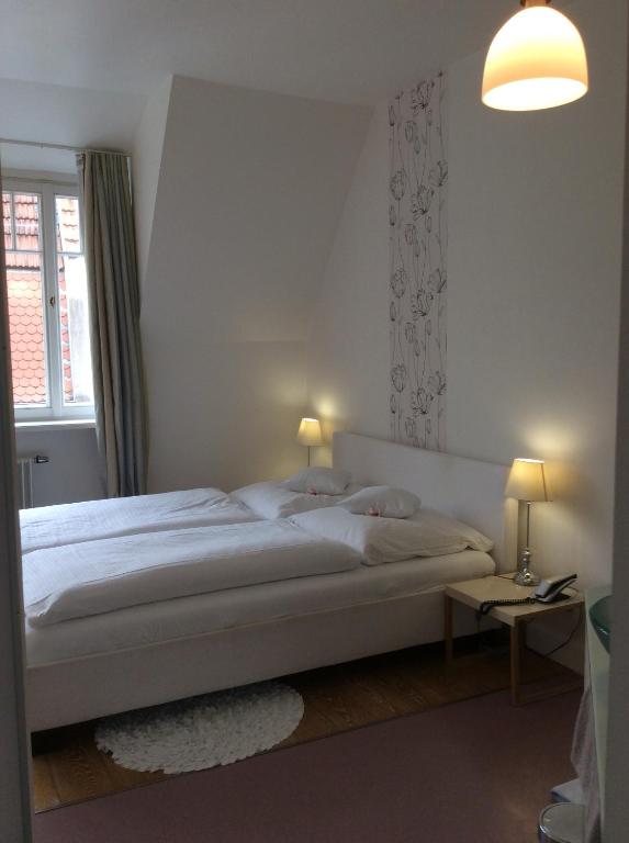 Postel nebo postele na pokoji v ubytování Hotel Heidelberg Astoria