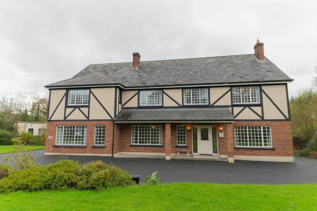 a large brick house with a white door at Dorney's B&B in Gorey