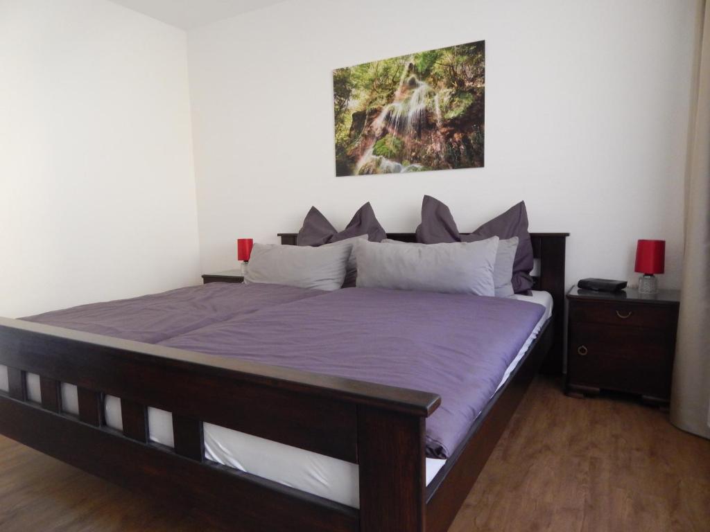 a bedroom with a large bed with purple sheets at FREE Apartment - Bei den Thermen in Bad Urach