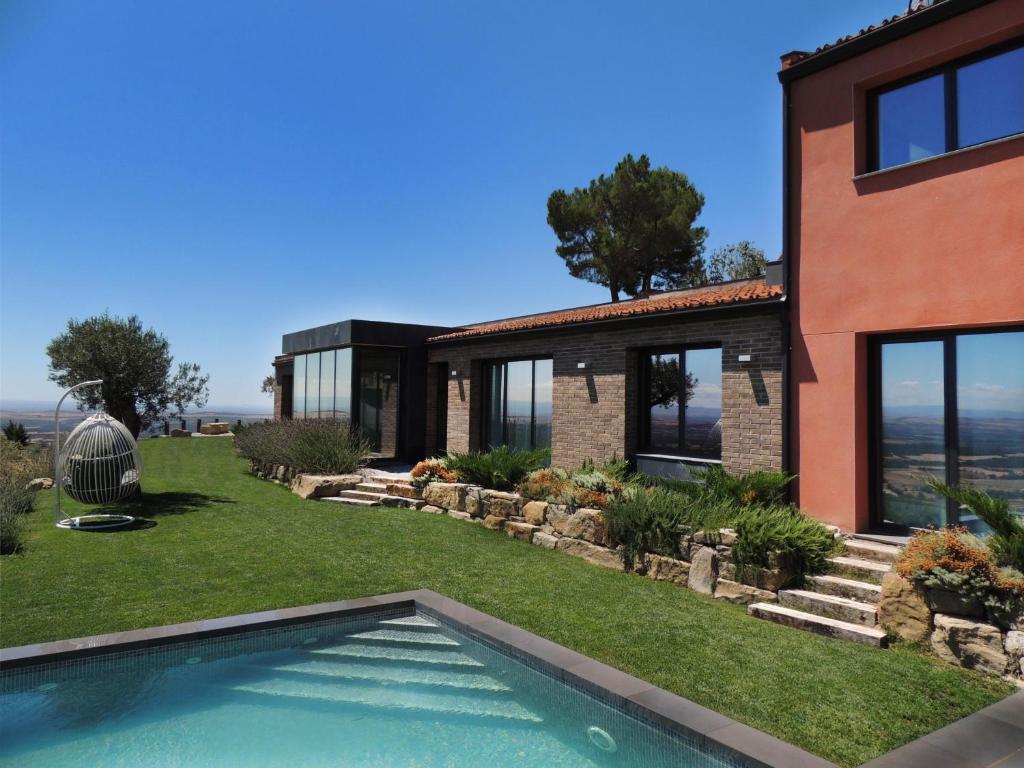 a house with a swimming pool in the yard at La Granja del Besa in Cubells