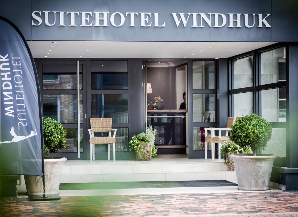 a building with a sign on the front of it at Das Windhuk in Westerland