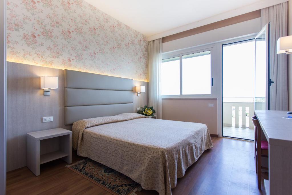 Postel nebo postele na pokoji v ubytování Hotel Benini