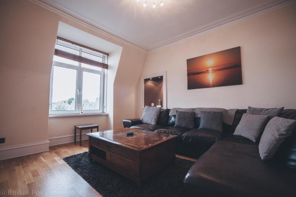 a living room with a couch and a coffee table at Prime 2 Bedroom City Centre Apt in Aberdeen