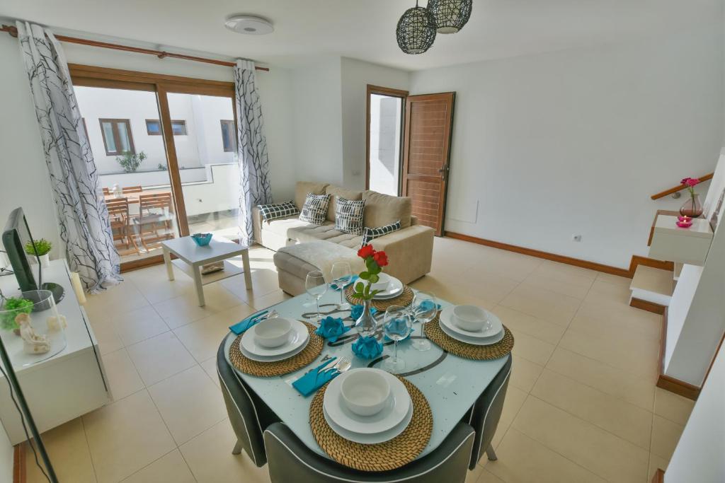 a living room with a table and chairs and a couch at Casa Zen in Puerto Calero