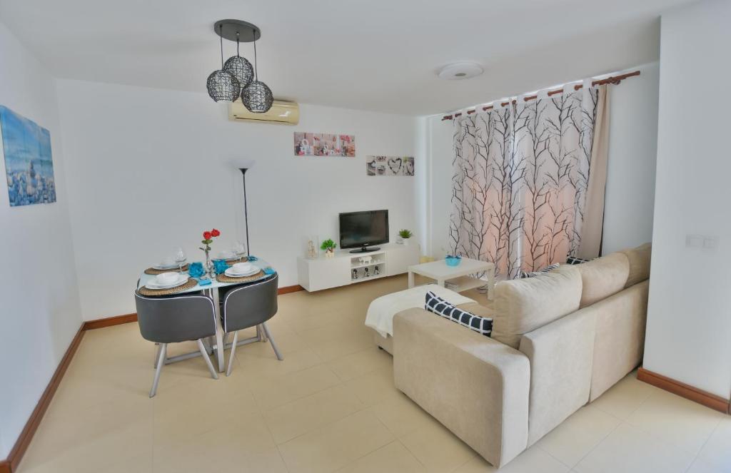 a living room with a couch and a table at Casa Zen in Puerto Calero