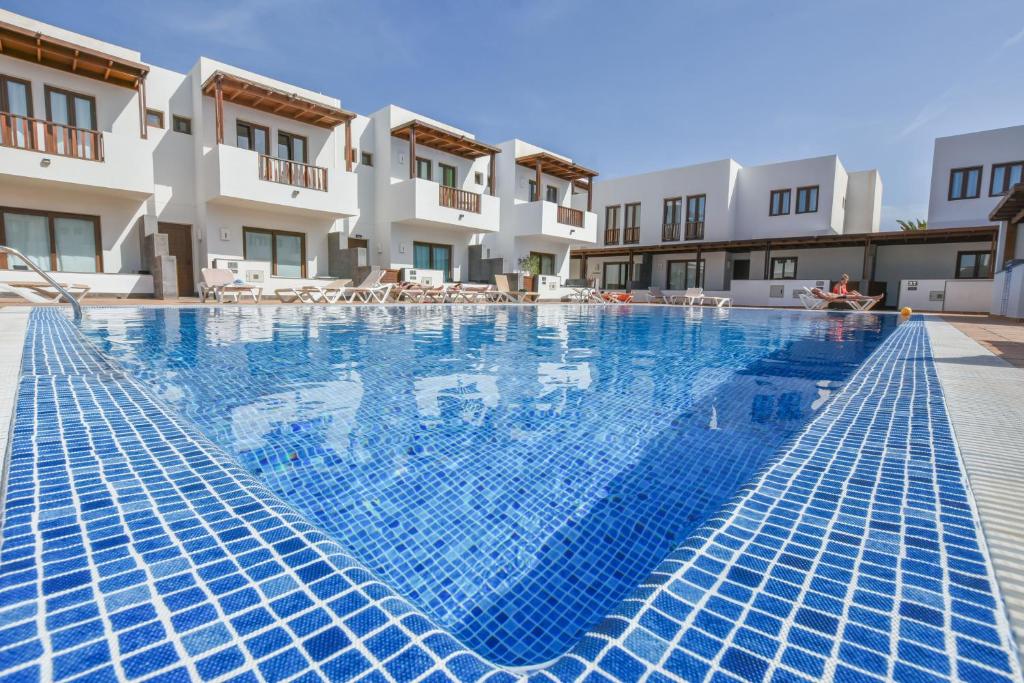 a large swimming pool in front of a building at Casa Zen in Puerto Calero
