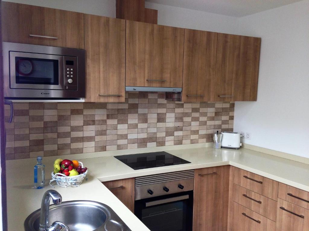 a kitchen with a sink and a microwave at Casa Zen in Puerto Calero