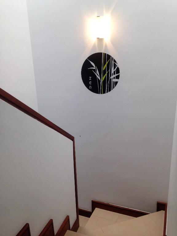 a light fixture on the wall next to a staircase at Casa Zen in Puerto Calero