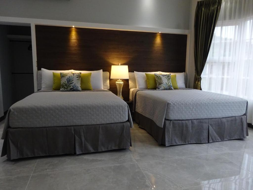 Postel nebo postele na pokoji v ubytování Alameda Cariari Boutique Hotel
