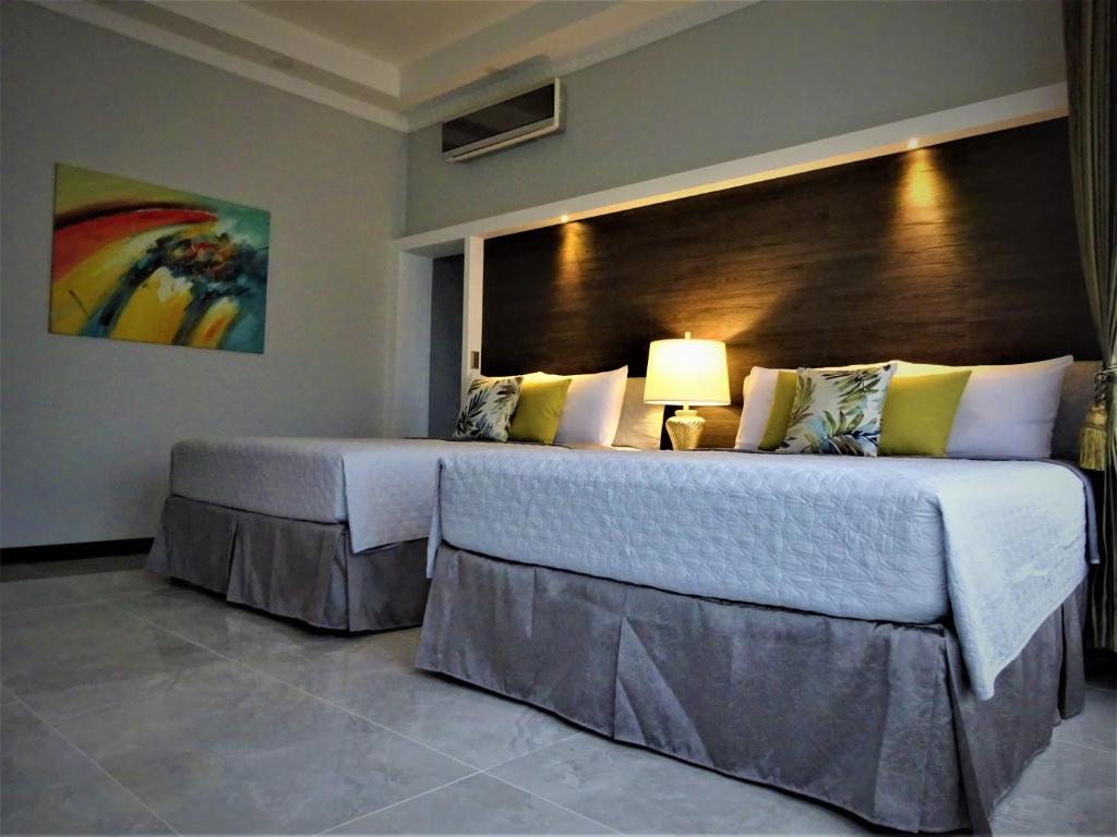 Postel nebo postele na pokoji v ubytování Alameda Cariari Boutique Hotel