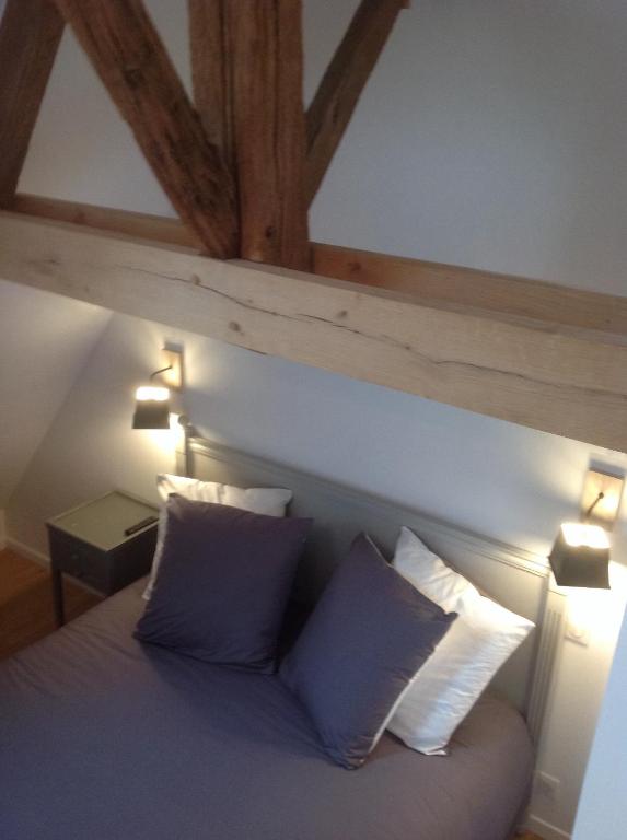 a bedroom with a bed with two pillows at Chambres d&#39;hôtes Saint Jean in Nogent-le-Rotrou