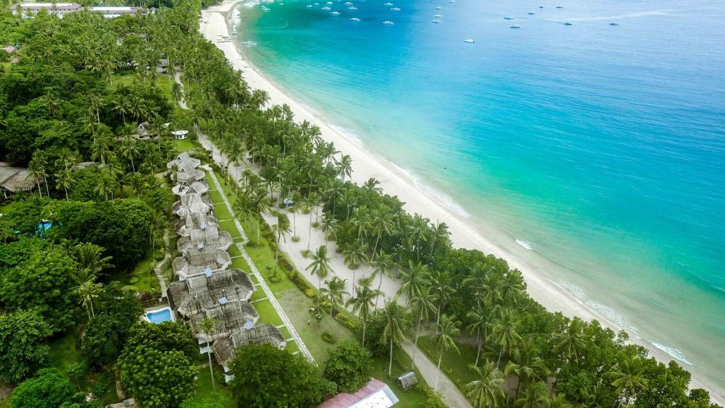 an aerial view of a beach with palm trees and the ocean at Daluyon Beach and Mountain Resort in Sabang