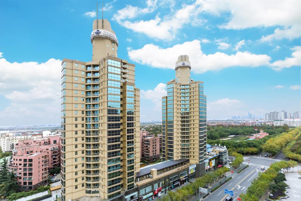 a view of two tall buildings in a city at Green Court Residence Jinqiao Diamond Shanghai in Shanghai