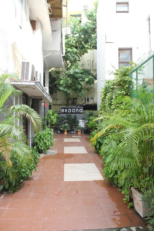 a walkway in a building with plants on it at Ekanaa Cottages in Chennai