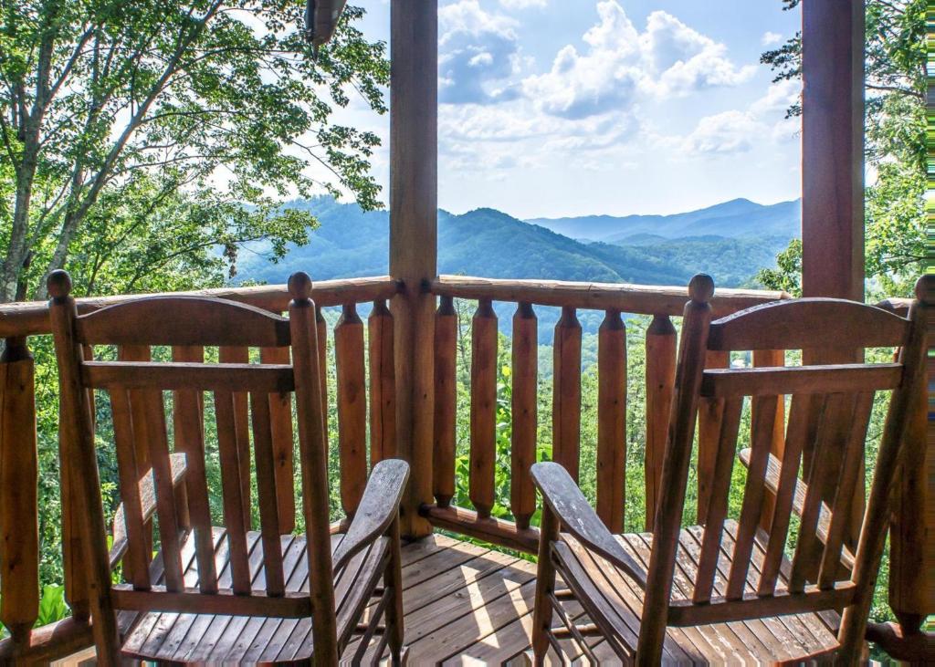 two chairs on a porch with a view of mountains at Scenic Serenity #75 in Sevierville