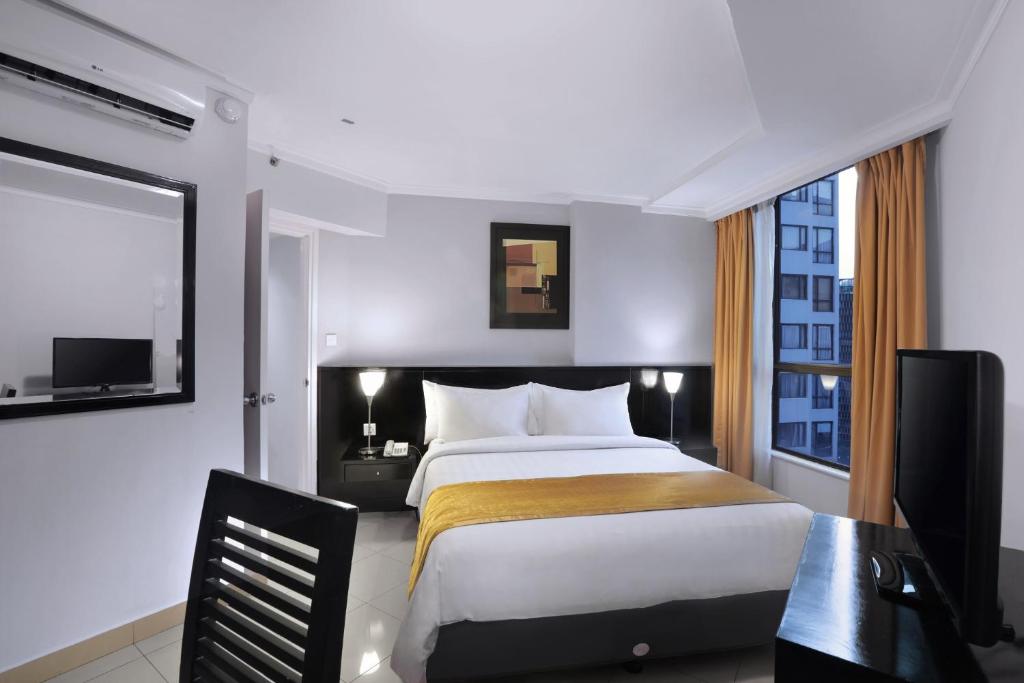 Postel nebo postele na pokoji v ubytování Horison Ultima Suite & Residences Rasuna Jakarta
