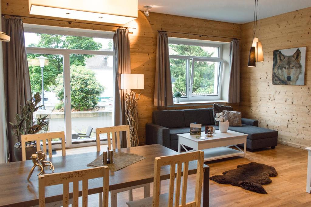 ein Wohnzimmer mit einem Tisch und einem Sofa in der Unterkunft StrandBerg's Stadt Chalet in Braunlage