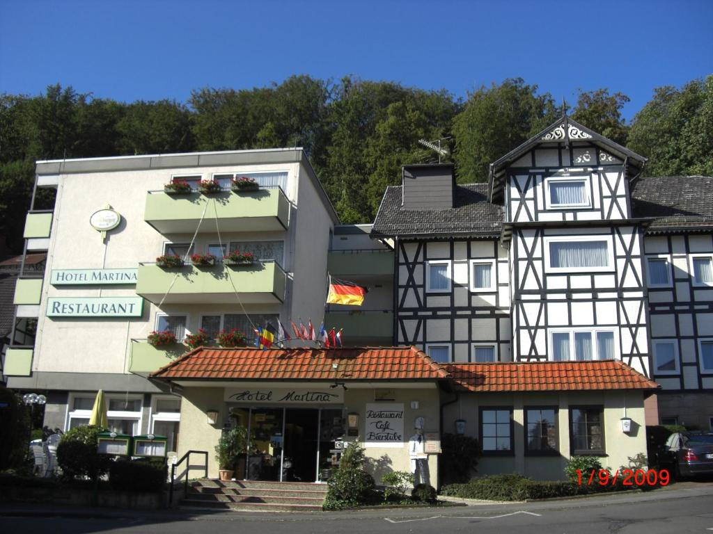 a black and white building next to a street at Hotel Martina in Bad Sooden-Allendorf
