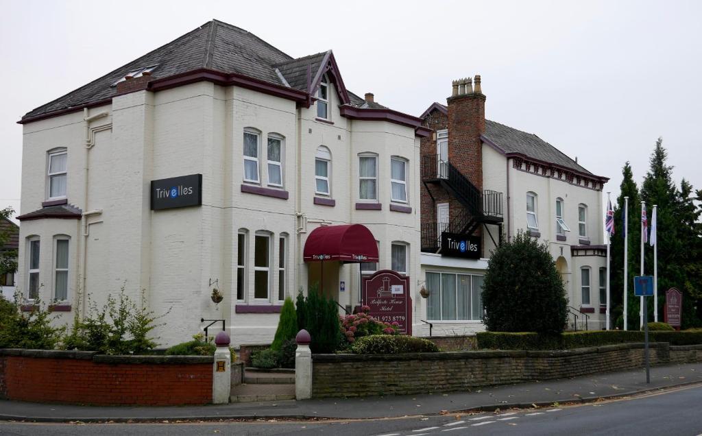 a large white house with a sign on it at Trivelles Belforte Hotel in Sale