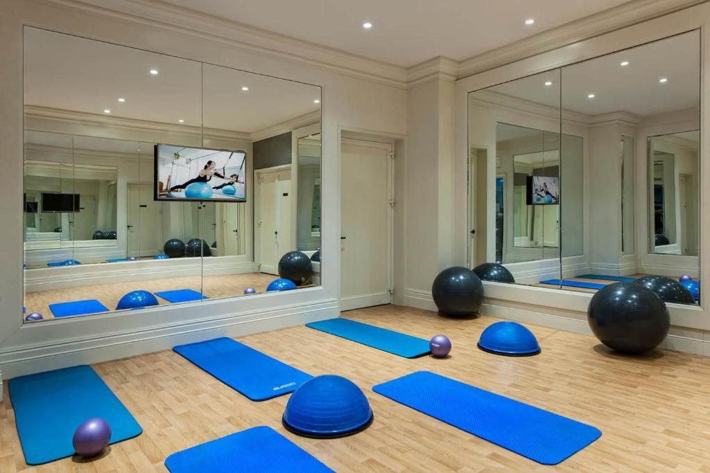a yoga room with blue mats and mirrors at Elite World Istanbul Florya in Istanbul