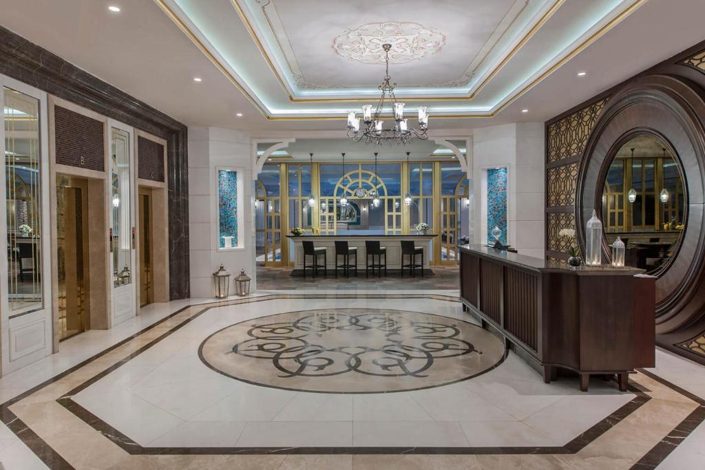 a large lobby with a table and a chandelier at Elite World Istanbul Florya in Istanbul