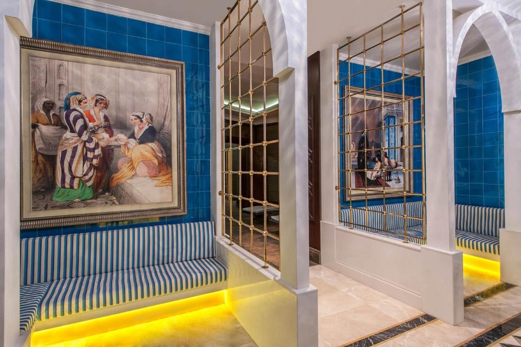 a room with blue walls and a painting on the wall at Elite World Istanbul Florya in Istanbul