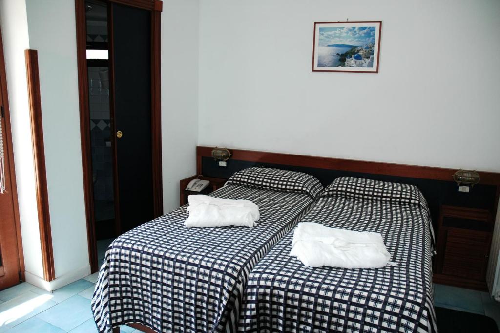 Postel nebo postele na pokoji v ubytování Hotel Il Faro