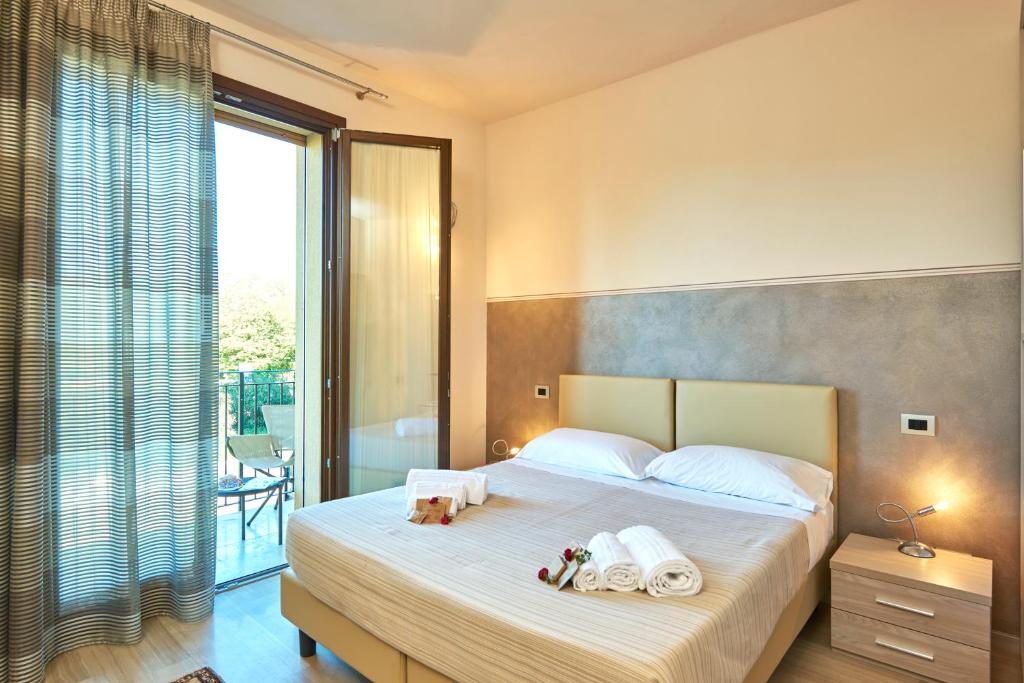 a bedroom with a bed with two towels on it at Domus Il Palio in Siena