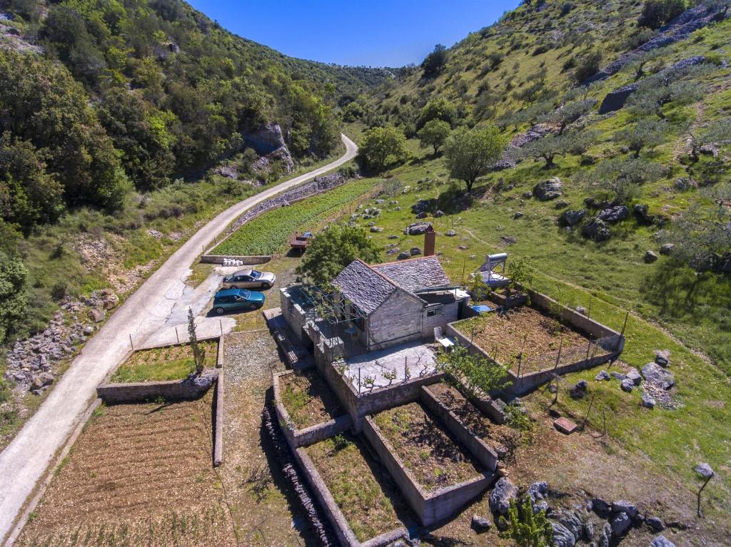 an aerial view of a house on a hill with a road at House Sv. Lovre in Postira