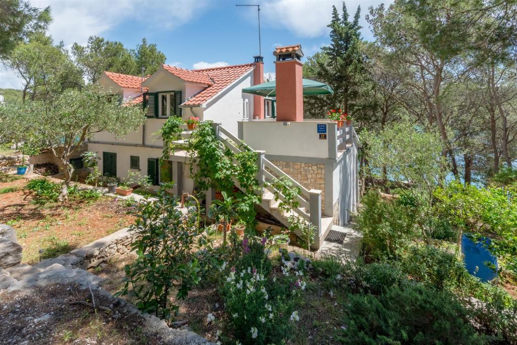 a house on a hill with trees at Apartment Ante in Milna