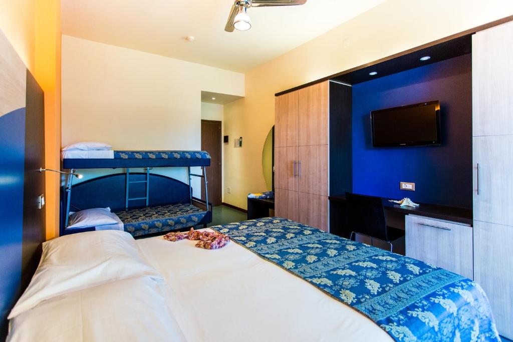 Postel nebo postele na pokoji v ubytování Hotel Sorriso