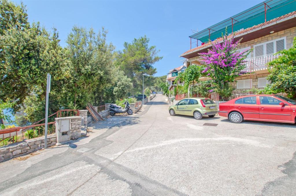 a street with two cars parked in front of a building at Apartment Ida in Brna