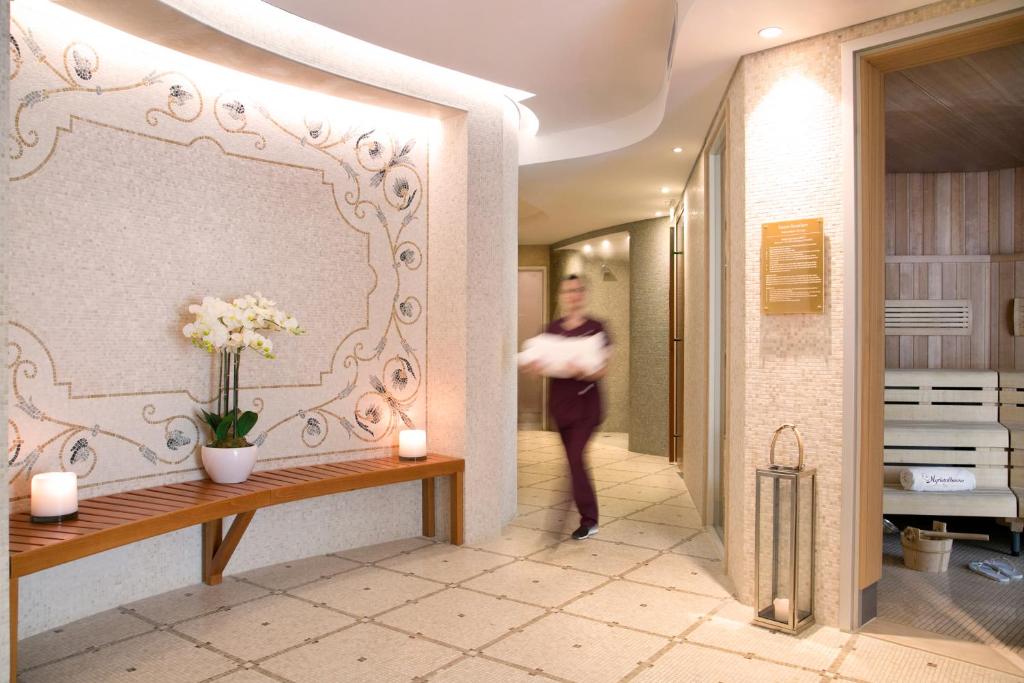 a woman walking through a hallway in a hotel room at Casale Panayiotis in Kalopanayiotis