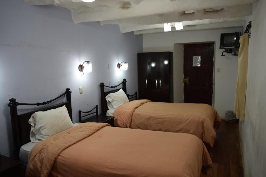 Postel nebo postele na pokoji v ubytování Hostal Qorichaska