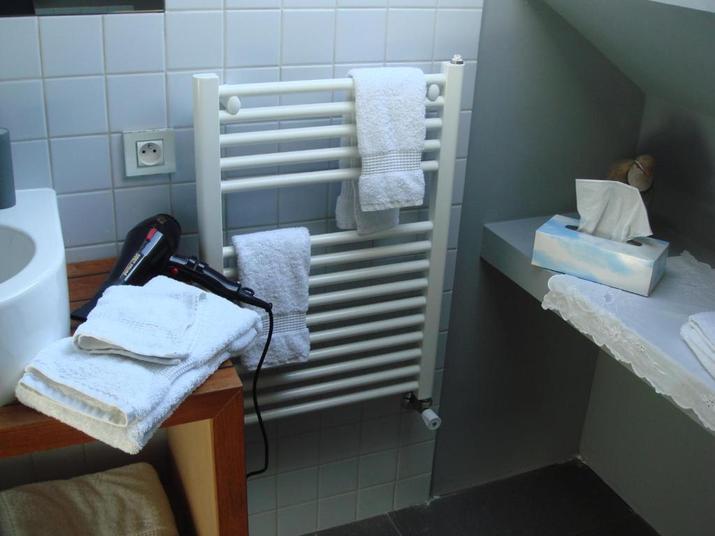 a bathroom with white towels and a sink at B&B Maison Angélus in Saint Malo