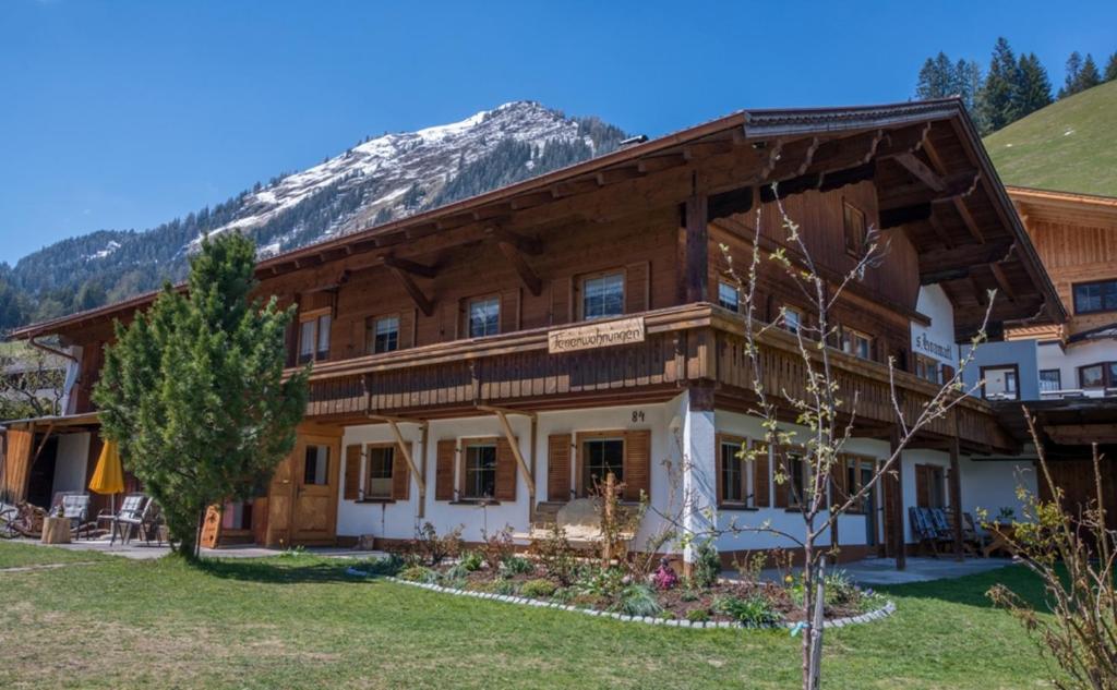 a house with a mountain in the background at Landhaus KATRIN in Holzgau