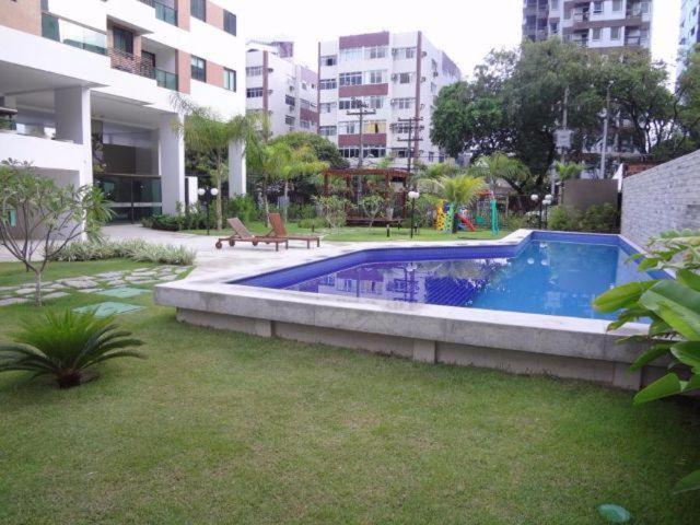 a swimming pool in a yard in a city at Flats Futuro Prince Prime in Recife