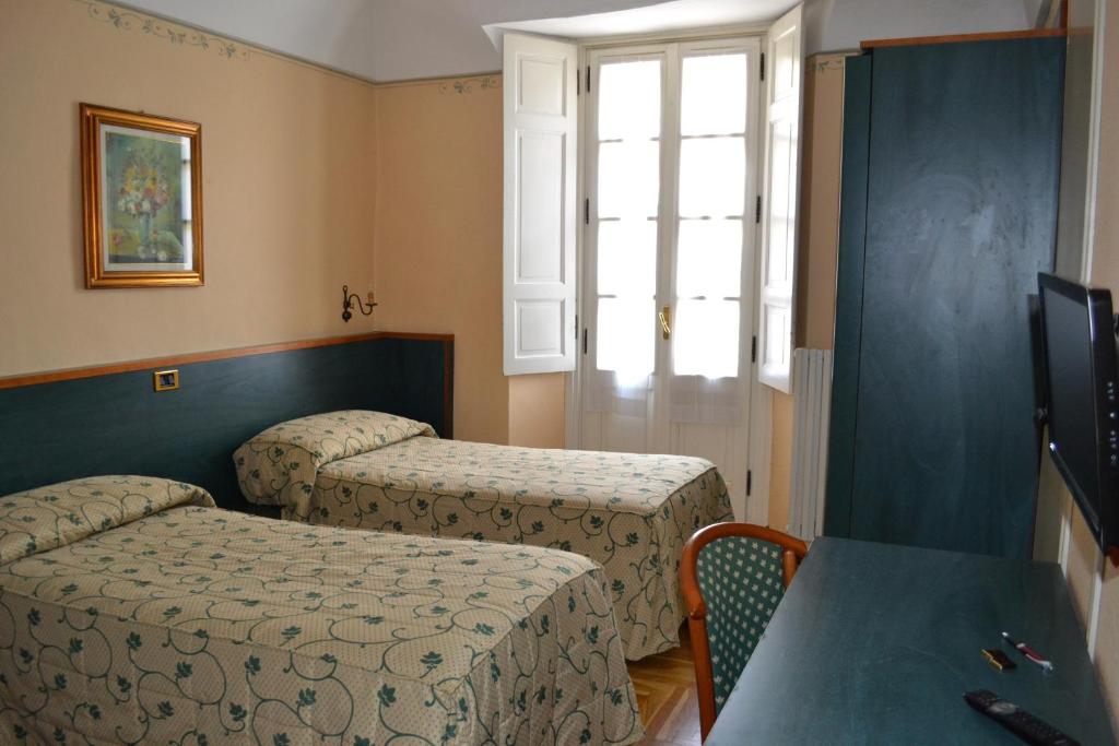 Postel nebo postele na pokoji v ubytování Albergo Italia