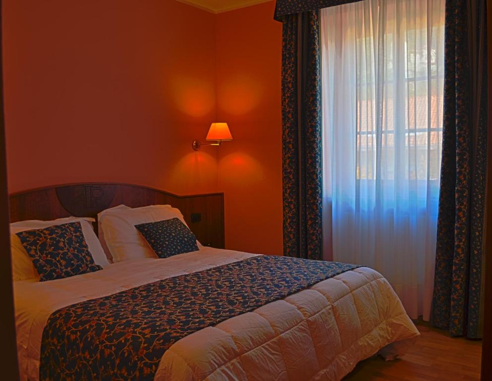 Postel nebo postele na pokoji v ubytování Albergo Italia