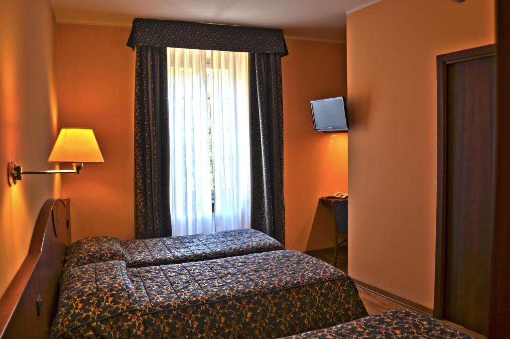 Postel nebo postele na pokoji v ubytování Albergo Italia