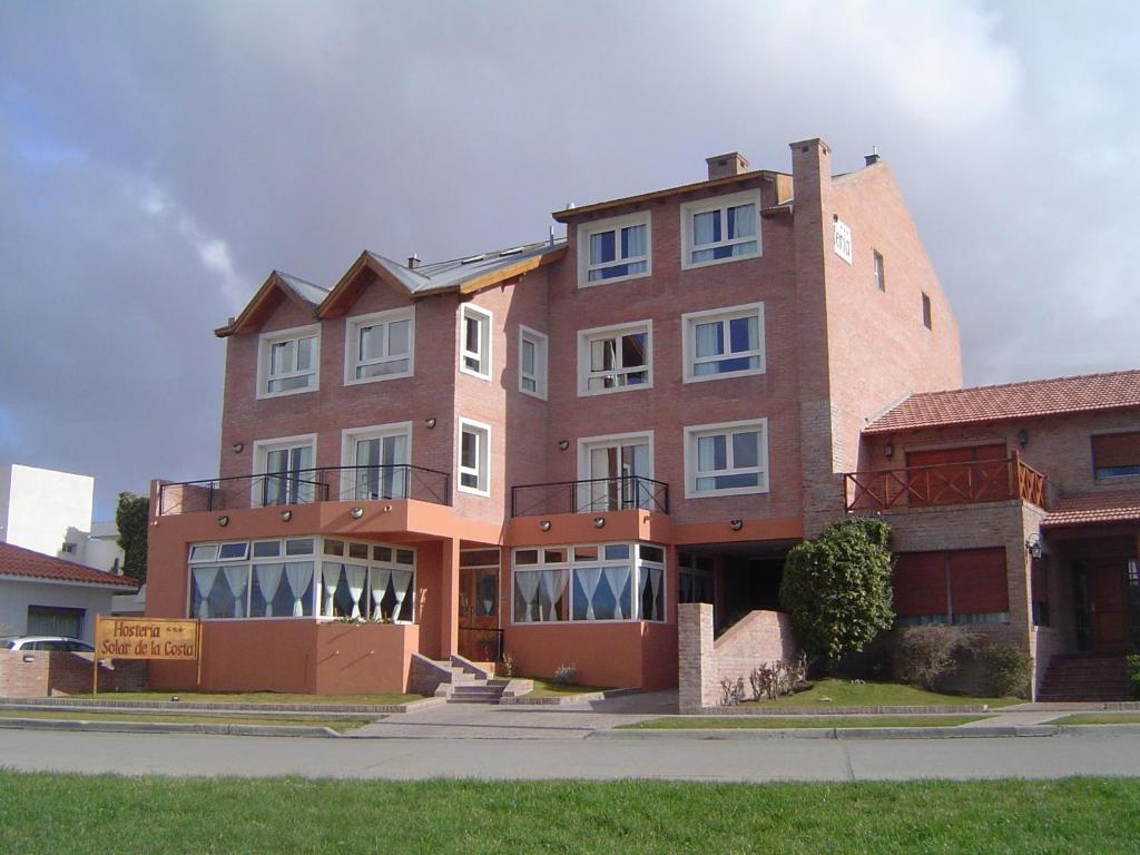 a large brick building on the side of a street at Hosteria Solar de la Costa in Puerto Madryn