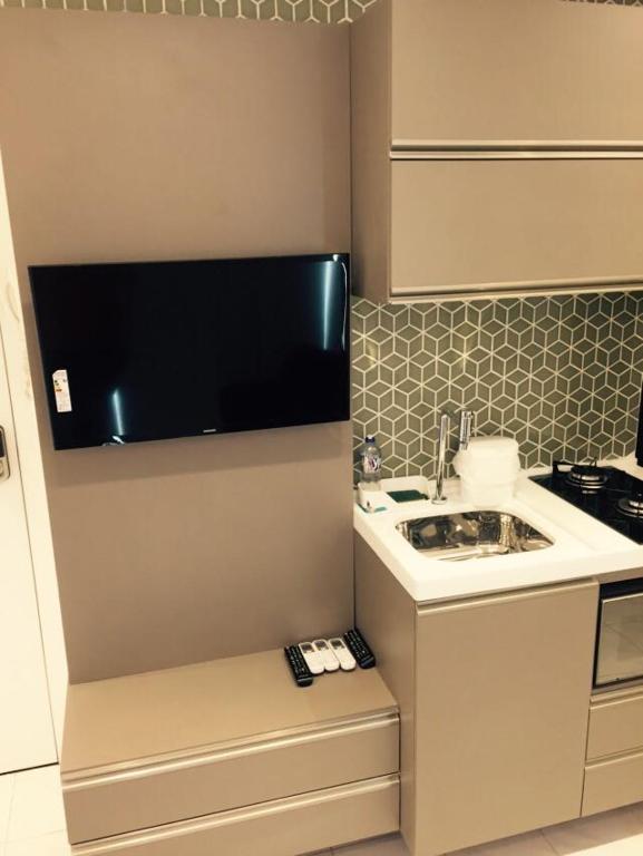a small kitchen with a sink and a counter at Flats Jaqueira Prime in Recife