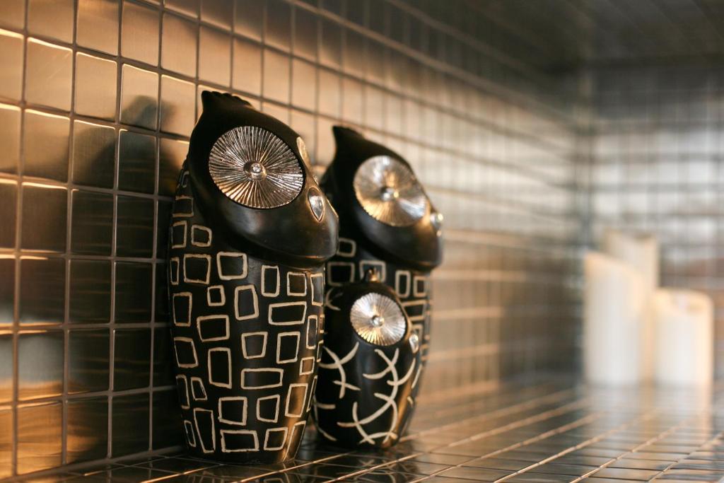 two vases sitting on a shelf in a room at Hotel Metro in London
