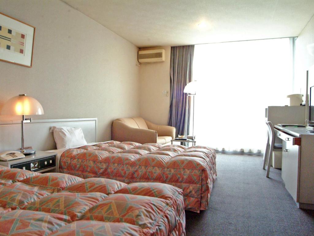 Postel nebo postele na pokoji v ubytování Tsumagoi Resort Sai no Sato