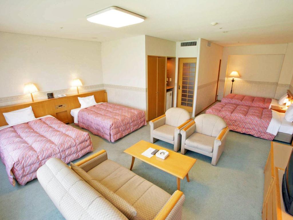Postel nebo postele na pokoji v ubytování Tsumagoi Resort Sai no Sato