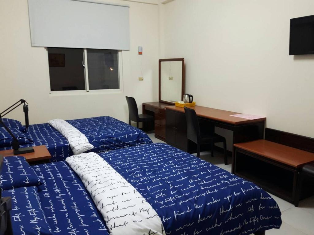 Postel nebo postele na pokoji v ubytování Hsianghua Guesthouse