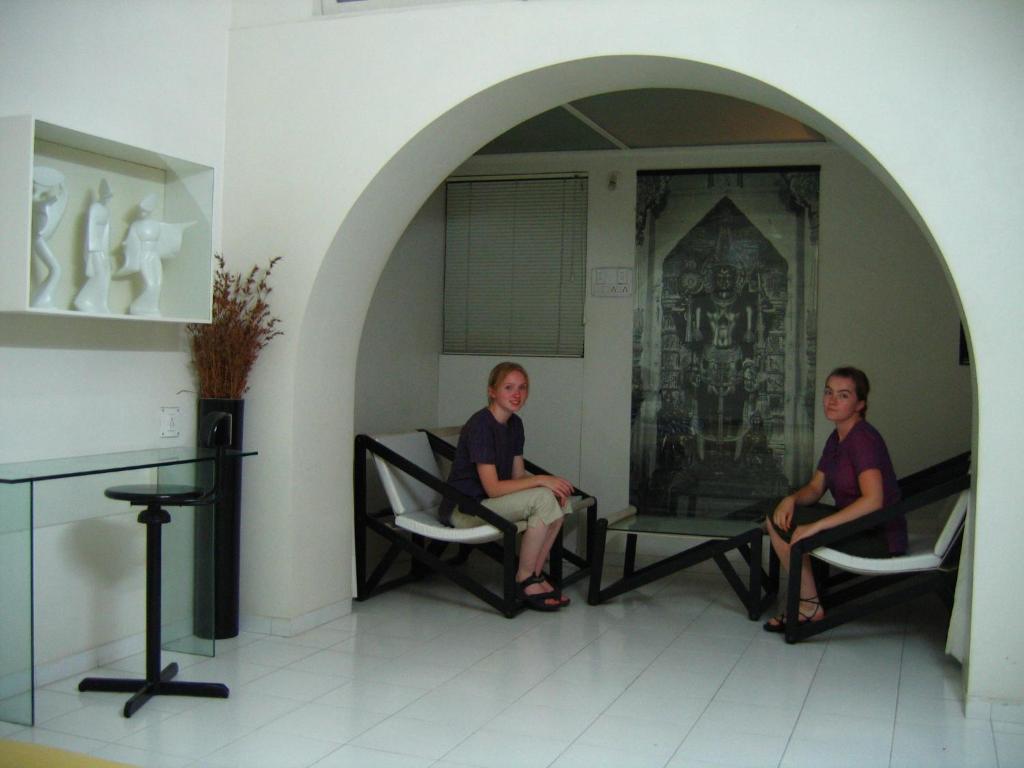 two women sitting in chairs in a room at Hotel Plaza (BOOKING FOR FOREIGN TOURIST ONLY) in Jālgaon